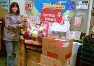 picture of Eileen Smulson with Ginger in a storage area of pet supplies.